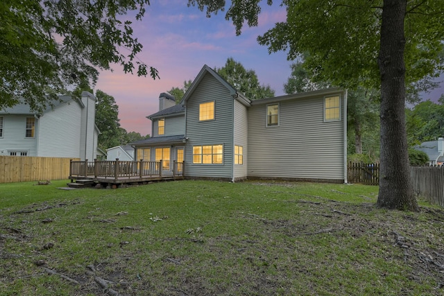 1616 Dotterers Run, Charleston, SC 29414 - back of property at dusk with a fenced backyard, a wooden deck, and a chimney