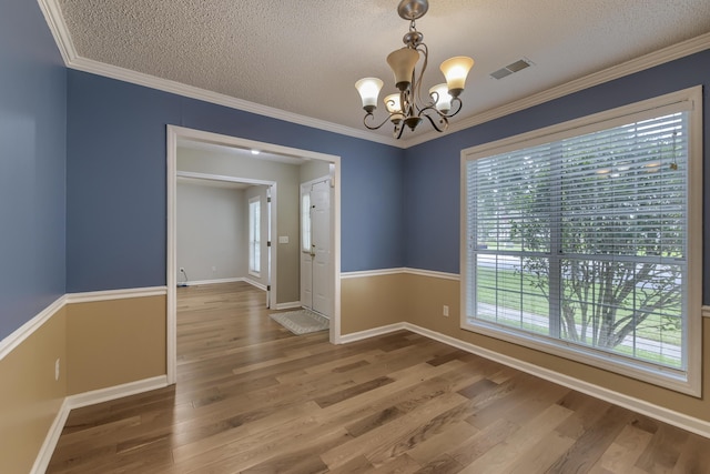 1616 Dotterers Run, Charleston, SC 29414 - empty room featuring a chandelier, a textured ceiling, wood finished floors, and ornamental molding
