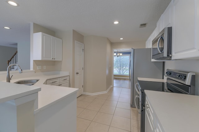 1616 Dotterers Run, Charleston, SC 29414 - kitchen with appliances with stainless steel finishes, light tile patterned floors, white cabinetry, light countertops, and recessed lighting