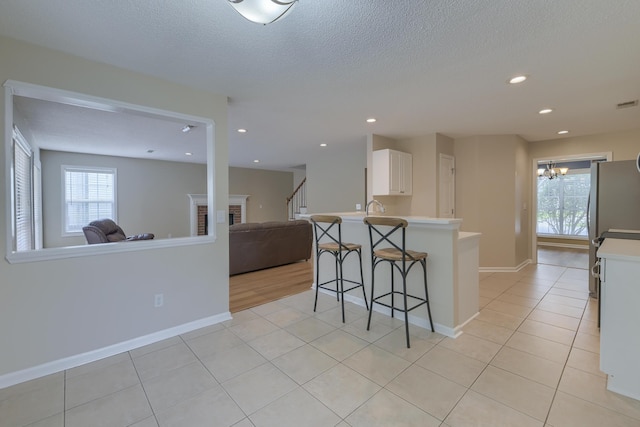 1616 Dotterers Run, Charleston, SC 29414 - kitchen with open floor plan, a breakfast bar area, plenty of natural light, recessed lighting, and a textured ceiling