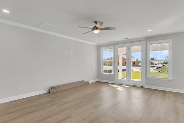 unfurnished room featuring baseboards, ornamental molding, and a healthy amount of sunlight