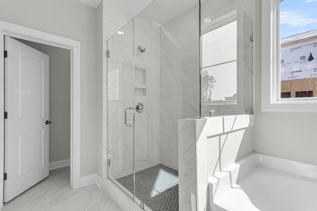 full bathroom featuring a bath, marble finish floor, and a shower stall