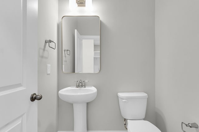 bathroom with toilet and a sink