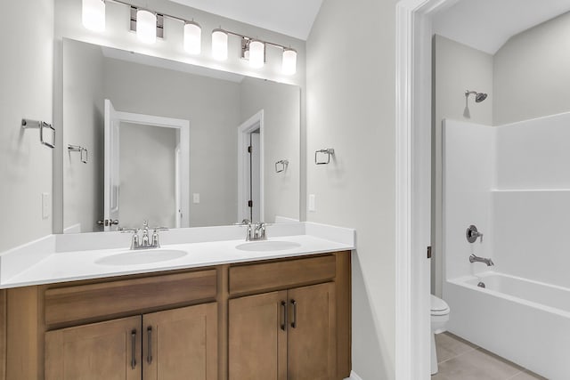 full bath with a sink, double vanity, toilet, and shower / bathtub combination