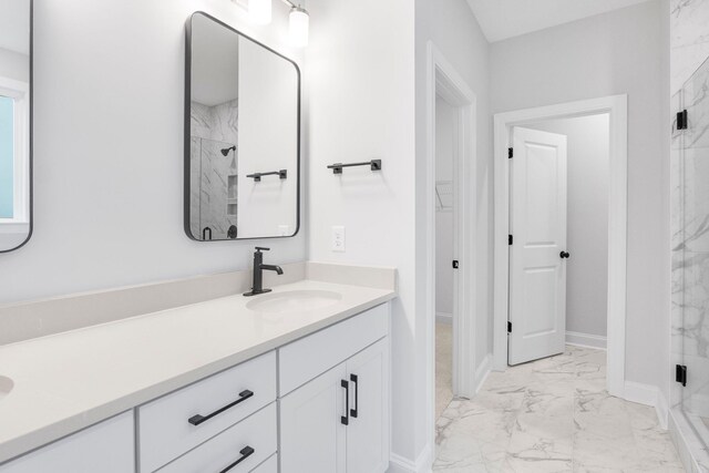 bathroom featuring vanity and a shower with shower door