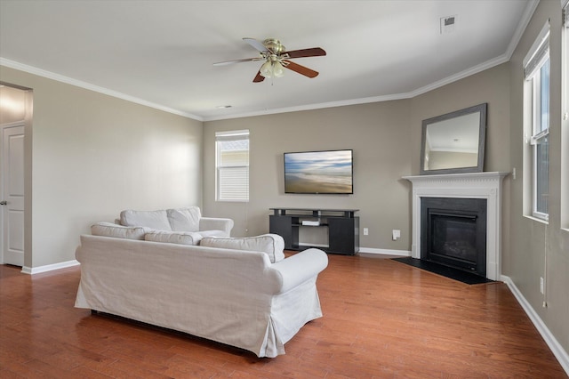 364 Deep River Rd, Summerville, SC 29486 - living area with crown molding, ceiling fan, baseboards, a fireplace with flush hearth, and wood finished floors