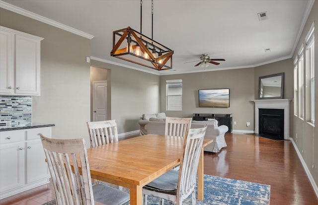 364 Deep River Rd, Summerville, SC 29486 - dining room featuring crown molding, a fireplace with flush hearth, baseboards, a ceiling fan, and light wood finished floors