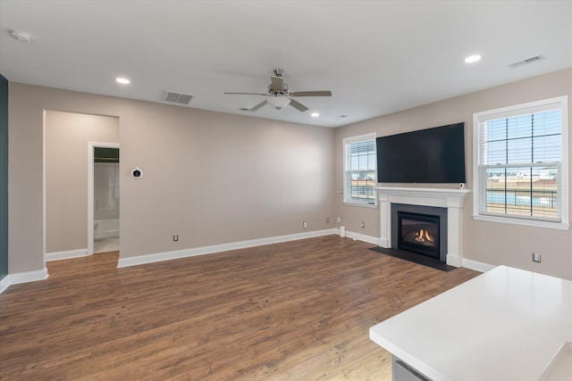 living room with ceiling fan and dark wood-type flooring