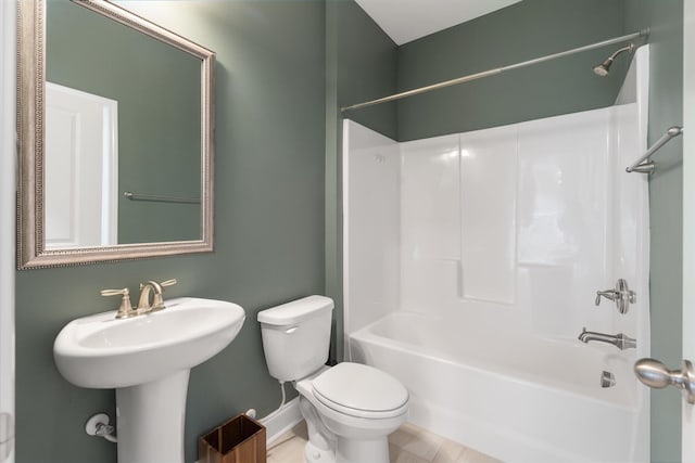 bathroom featuring tile patterned flooring, shower / bathtub combination, and toilet