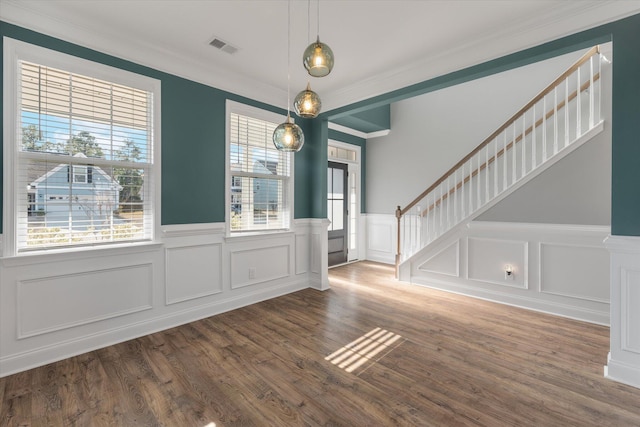 foyer with crown molding and dark hardwood / wood-style floors