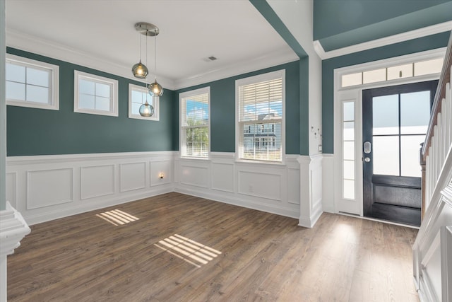 entrance foyer with crown molding and dark wood-type flooring