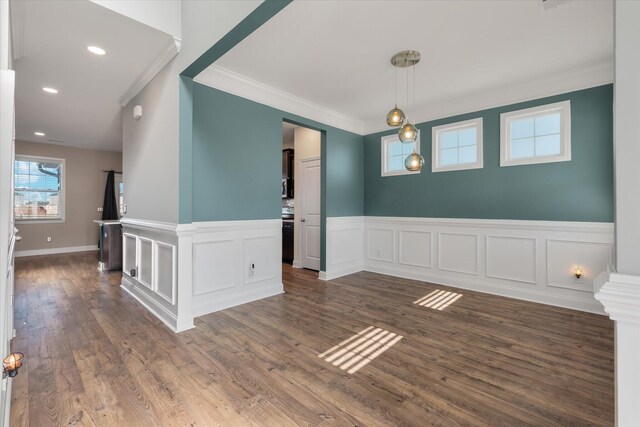 empty room featuring crown molding and dark hardwood / wood-style flooring