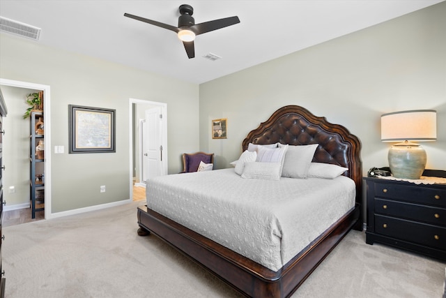 bedroom with baseboards, ceiling fan, visible vents, and light colored carpet