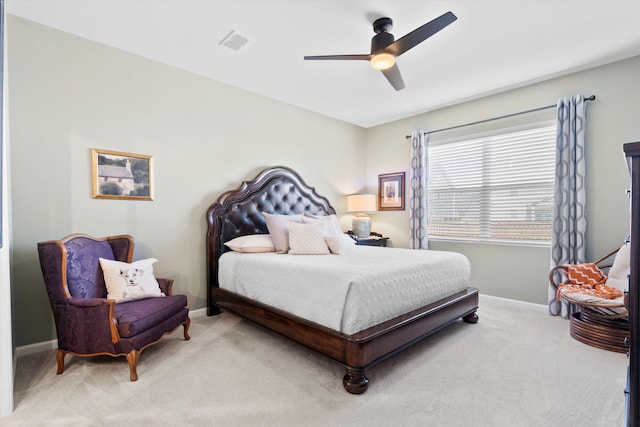 bedroom with baseboards, a ceiling fan, visible vents, and light colored carpet