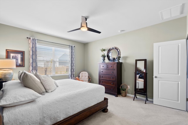 bedroom with ceiling fan, visible vents, baseboards, and light colored carpet