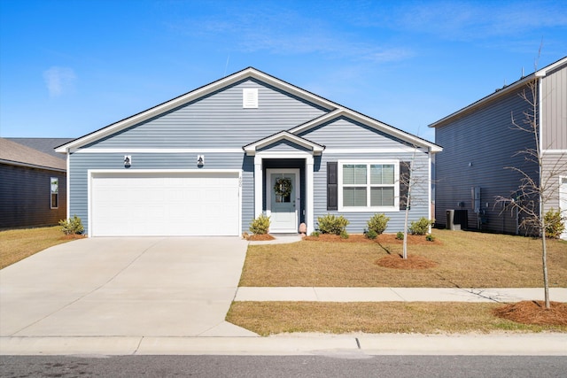 ranch-style home featuring an attached garage, driveway, central AC unit, and a front yard