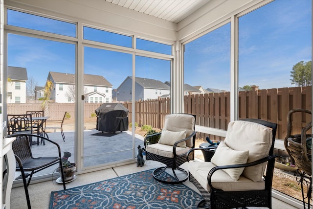 sunroom with a residential view and plenty of natural light