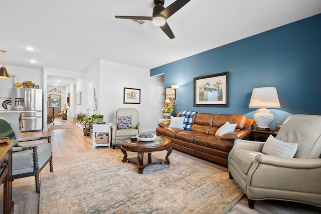 living room featuring recessed lighting, visible vents, ceiling fan, and wood finished floors