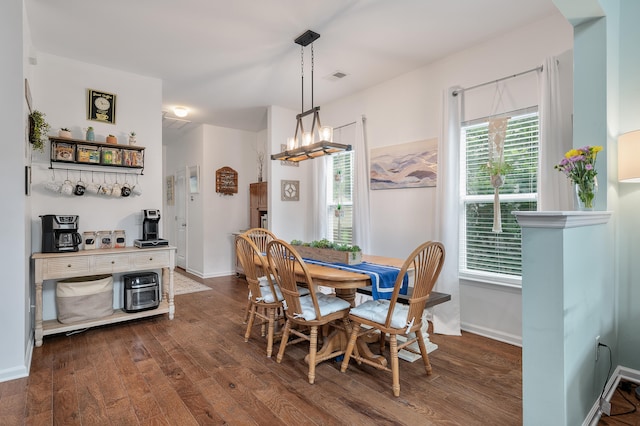 dining area featuring a chandelier and dark hardwood / wood-style floors