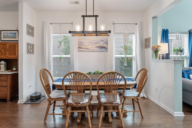 dining room with dark hardwood / wood-style flooring