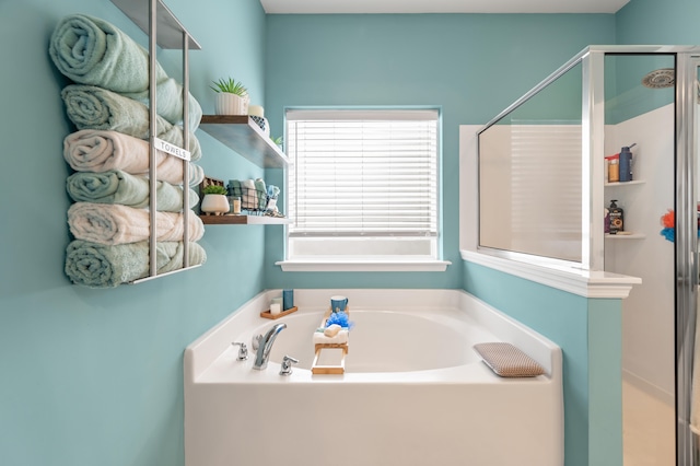 bathroom featuring shower with separate bathtub