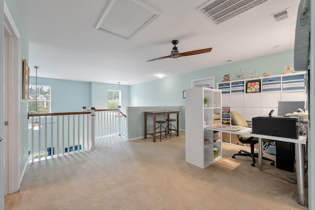 carpeted home office featuring ceiling fan