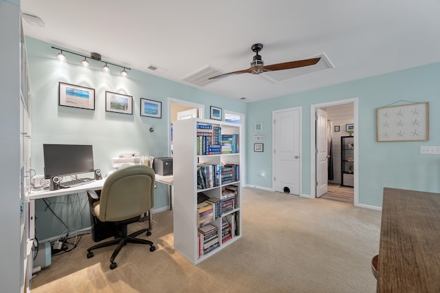 office space featuring light carpet and ceiling fan