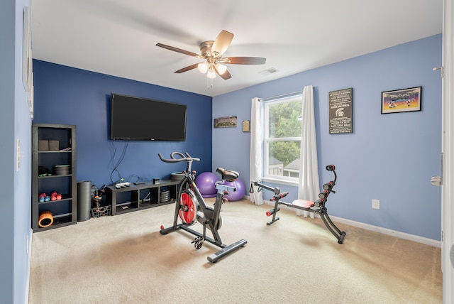 exercise room featuring ceiling fan and carpet