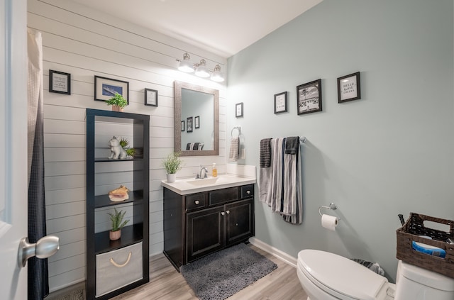 bathroom featuring vanity, hardwood / wood-style flooring, and toilet