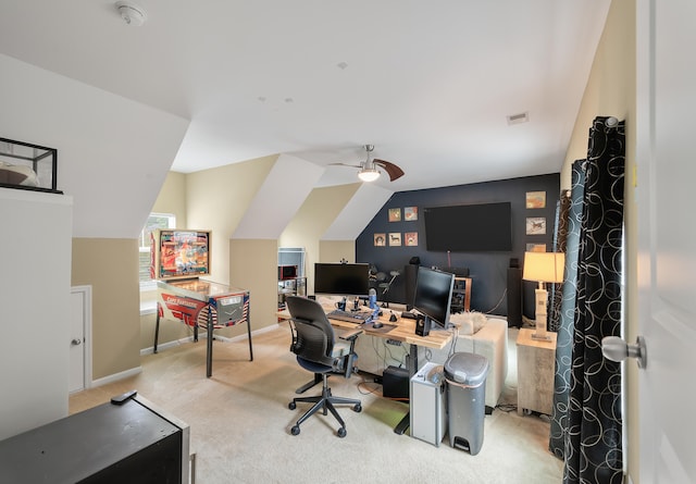 home office featuring vaulted ceiling, light carpet, and ceiling fan