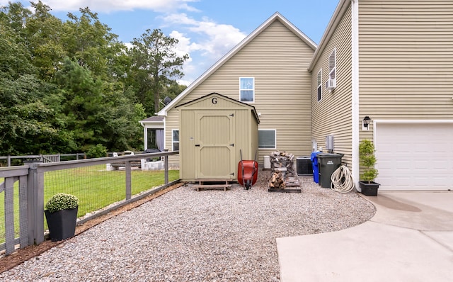 exterior space featuring a garage, central air condition unit, and a lawn