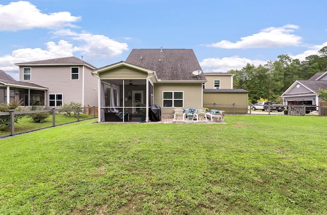 back of property with a yard and a sunroom