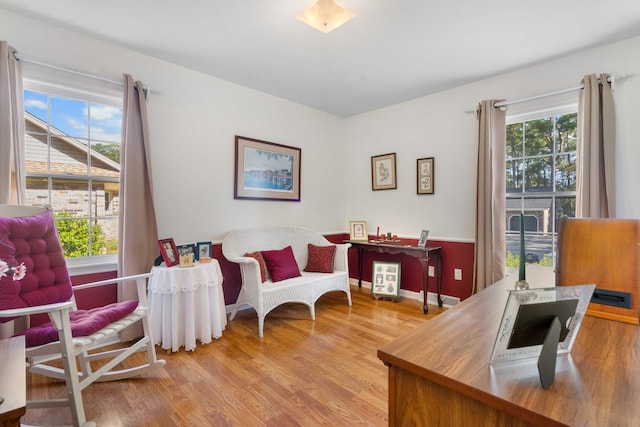 sitting room featuring a healthy amount of sunlight and light hardwood / wood-style flooring