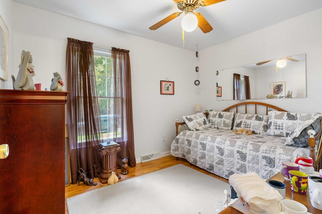 bedroom featuring hardwood / wood-style floors and ceiling fan