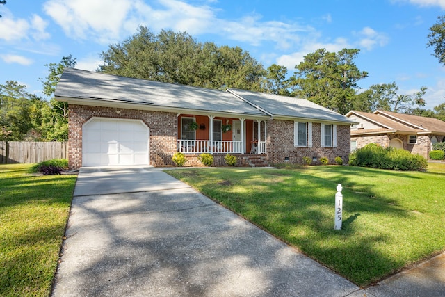 ranch-style home featuring covered porch, a front lawn, and a garage