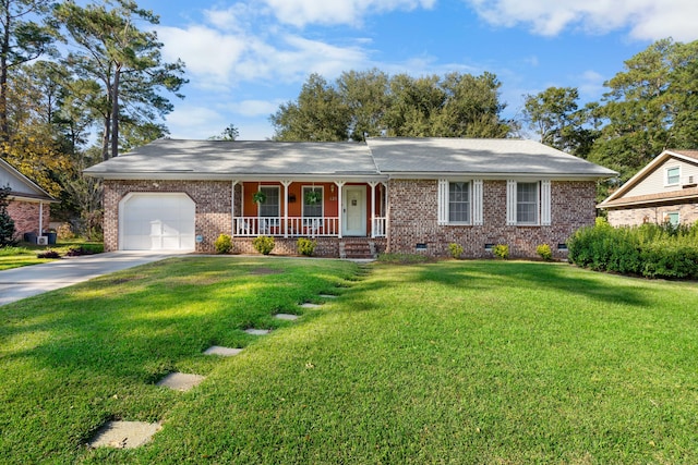 ranch-style house featuring a front yard, covered porch, and a garage