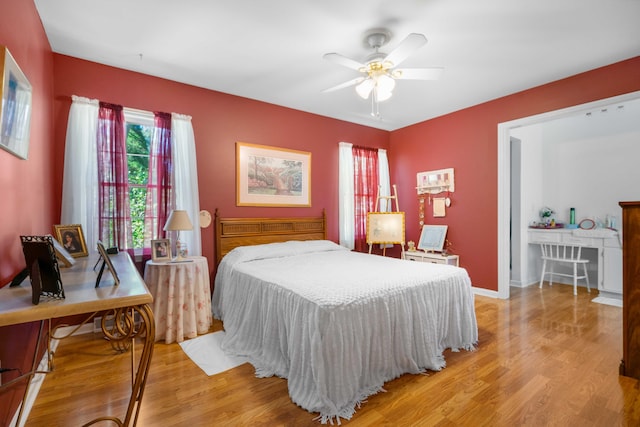 bedroom with light hardwood / wood-style floors and ceiling fan