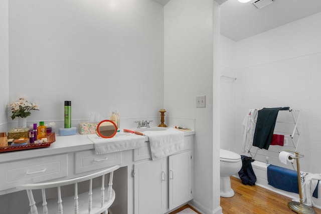 bathroom featuring vanity, toilet, a shower, and hardwood / wood-style floors