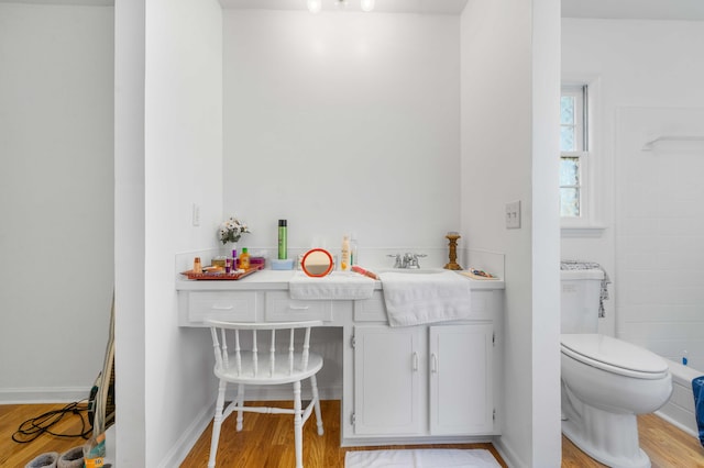 bathroom featuring vanity, toilet, and hardwood / wood-style flooring