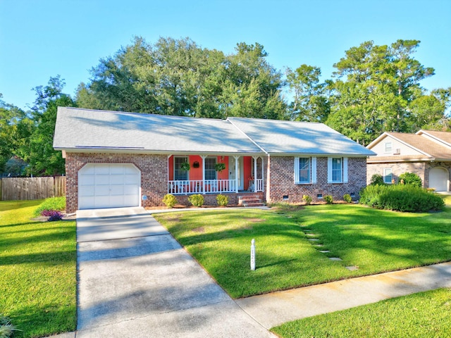 ranch-style house featuring a front yard, covered porch, and a garage