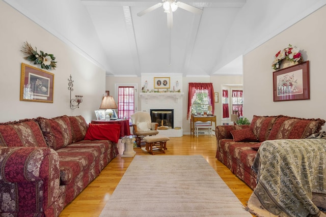 living room with lofted ceiling with beams, light wood-type flooring, and ceiling fan