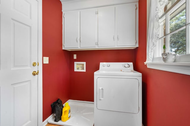 clothes washing area with washer / dryer and cabinets