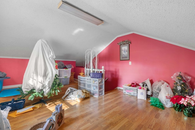 bonus room with lofted ceiling, a textured ceiling, and hardwood / wood-style flooring