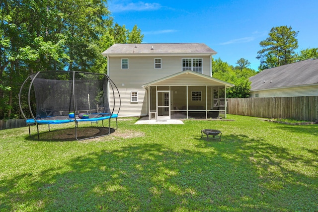 214 Blackstone Dr, Moncks Corner, SC 29461 - rear view of house with a trampoline, a fire pit, and a sunroom