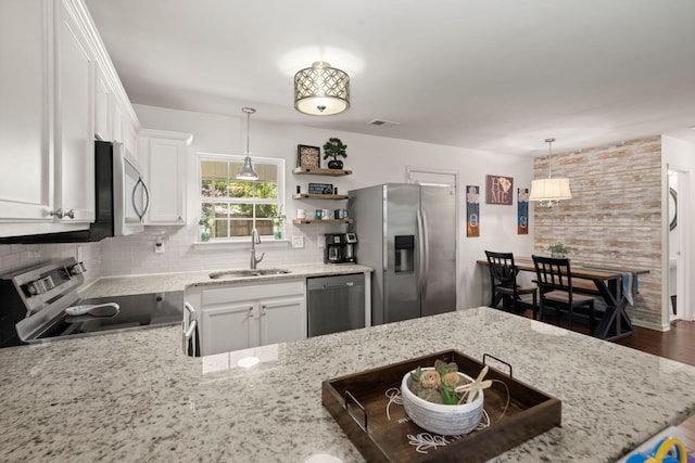 214 Blackstone Dr, Moncks Corner, SC 29461 - kitchen featuring appliances with stainless steel finishes, a sink, tasteful backsplash, light stone countertops, and white cabinetry