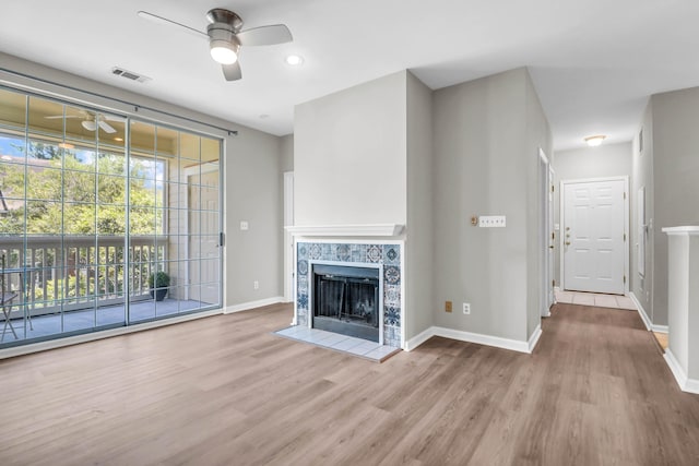 1600 Long Grove Dr Unit 423, Mount Pleasant, SC 29464 - unfurnished living room with ceiling fan, wood finished floors, and a tiled fireplace