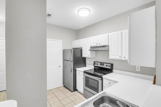 1600 Long Grove Dr Unit 423, Mount Pleasant, SC 29464 - kitchen with stainless steel appliances, under cabinet range hood, light tile patterned flooring, light countertops, and white cabinets