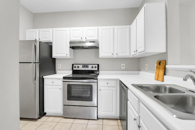1600 Long Grove Dr Unit 423, Mount Pleasant, SC 29464 - kitchen with stainless steel appliances, range hood, light tile patterned floors, and white cabinetry