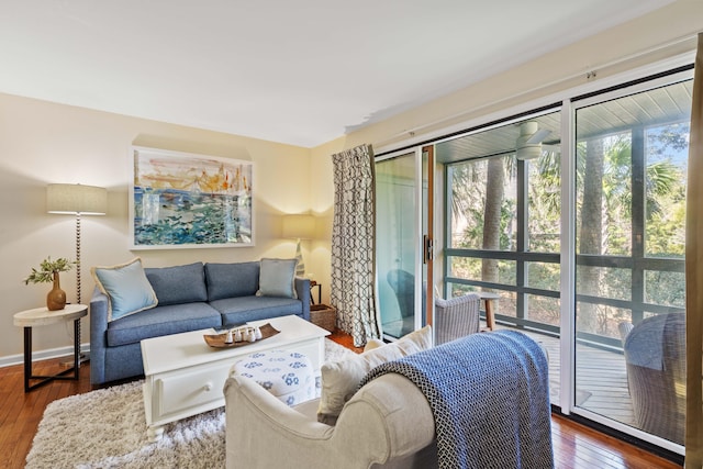 living area with baseboards and hardwood / wood-style floors