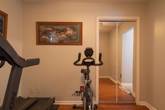 359 Muirfield Pkwy, Charleston, SC 29414 - workout area with dark wood-style flooring and baseboards